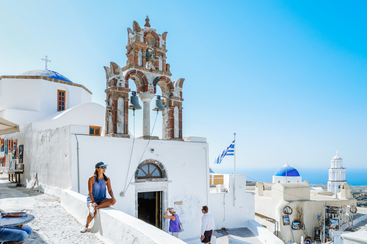 Woman sightseeing Santorini Greece winter holiday Europe