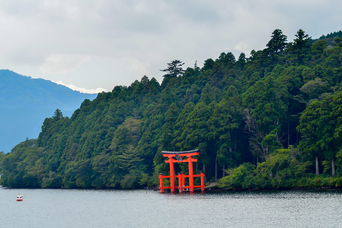 An iconic red gate of Hakone jinja shrine standing in Lake Ashi.