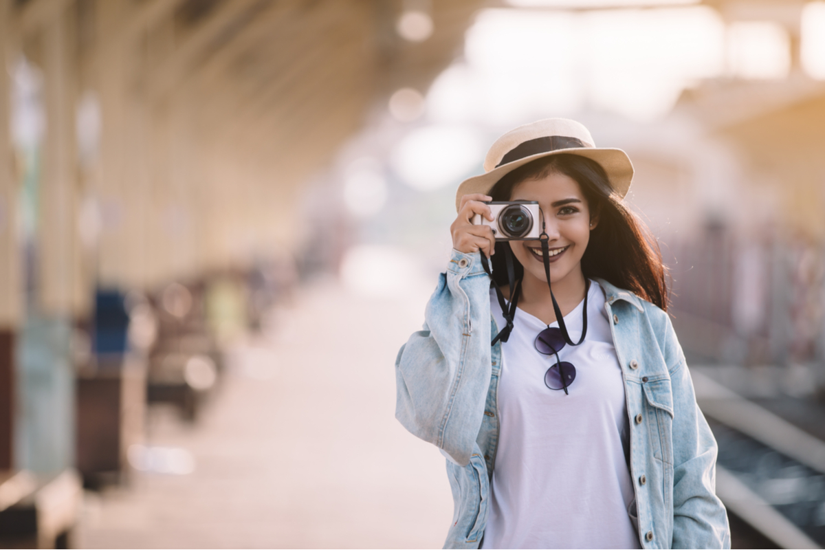 Woman taking photo at train station