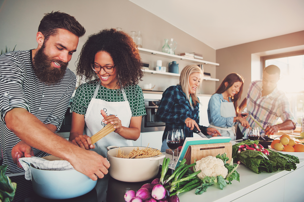 Group of friends cooking in kitchen