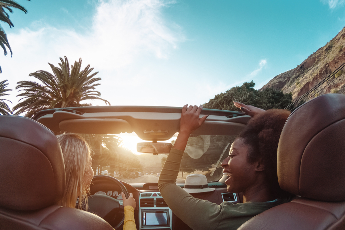 Two happy friends in car road trip