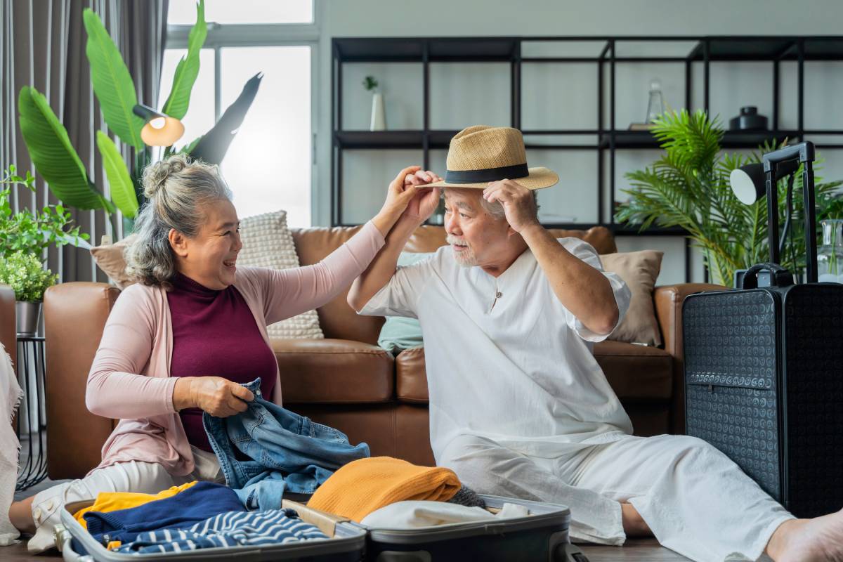 Older couple packing for a trip budget senior travel