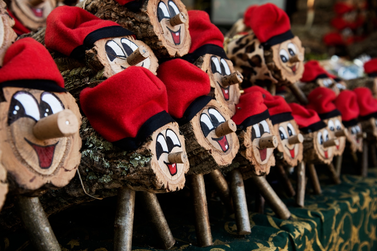 Pile of logs decorated as Tió de Nadal at Christmas in Spain