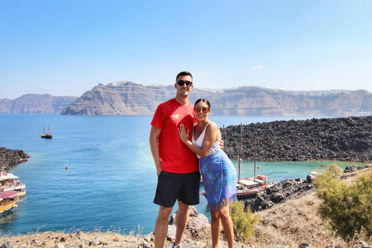 Couple sightseeing on sunny Santorini island in Greece