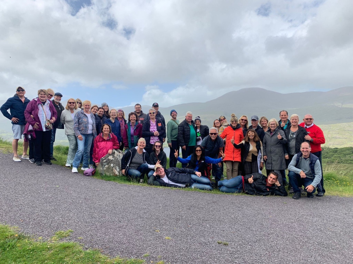 Happy tour group in the UK with their tour leader