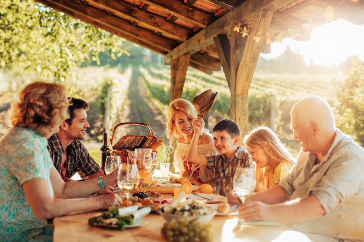 Family eating lunch at vineyard.